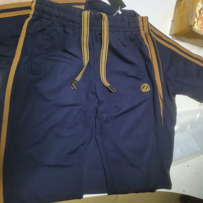 Man wearing a blue short sleeve polyester sports suit set, consisting of a top and matching pants.