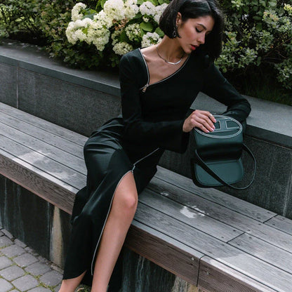 Elegant crossbody dress with zipper detail, high-waisted silhouette, and long sleeves in a solid black colour