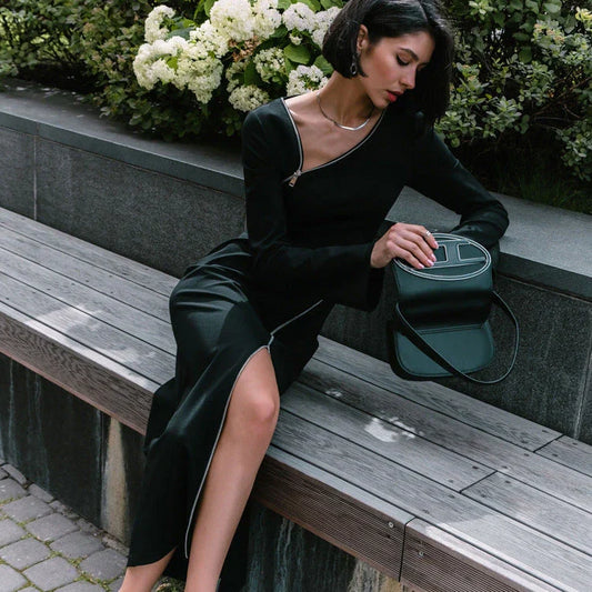 Elegant crossbody dress with zipper detail, high-waisted silhouette, and long sleeves in a solid black colour