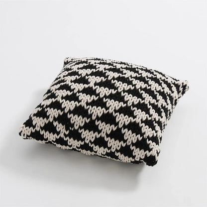 A luxurious hand-crocheted throw pillow with a chunky knit design, providing cosy comfort and elegant style for your home decor.