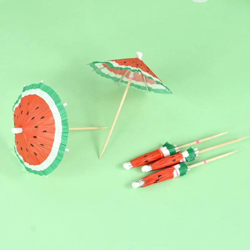 Colourful paper umbrella cake toppers in various patterns, including cartoon animals, flowers, and food items.