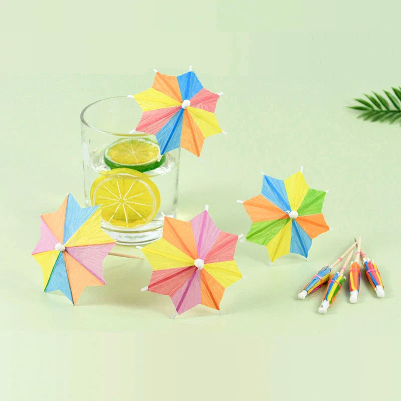 Colourful paper umbrella cake toppers in various patterns, including cartoon animals, flowers, and food items.