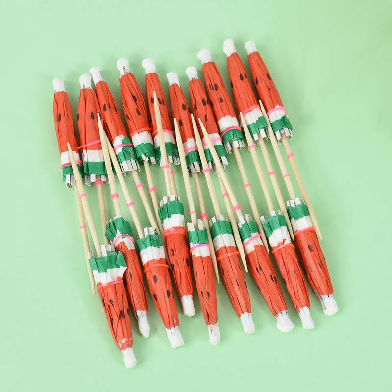 Colourful paper umbrella cake toppers in various patterns, including cartoon animals, flowers, and food items.