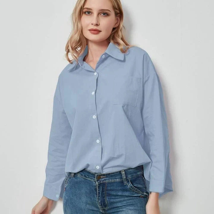 Elegant vintage-inspired blue oversize blouse with a sophisticated turn-down collar and full-length sleeves