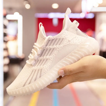 Men's white low-top sports shoes with mesh lining, round toe, and visible stitching on a grey background.