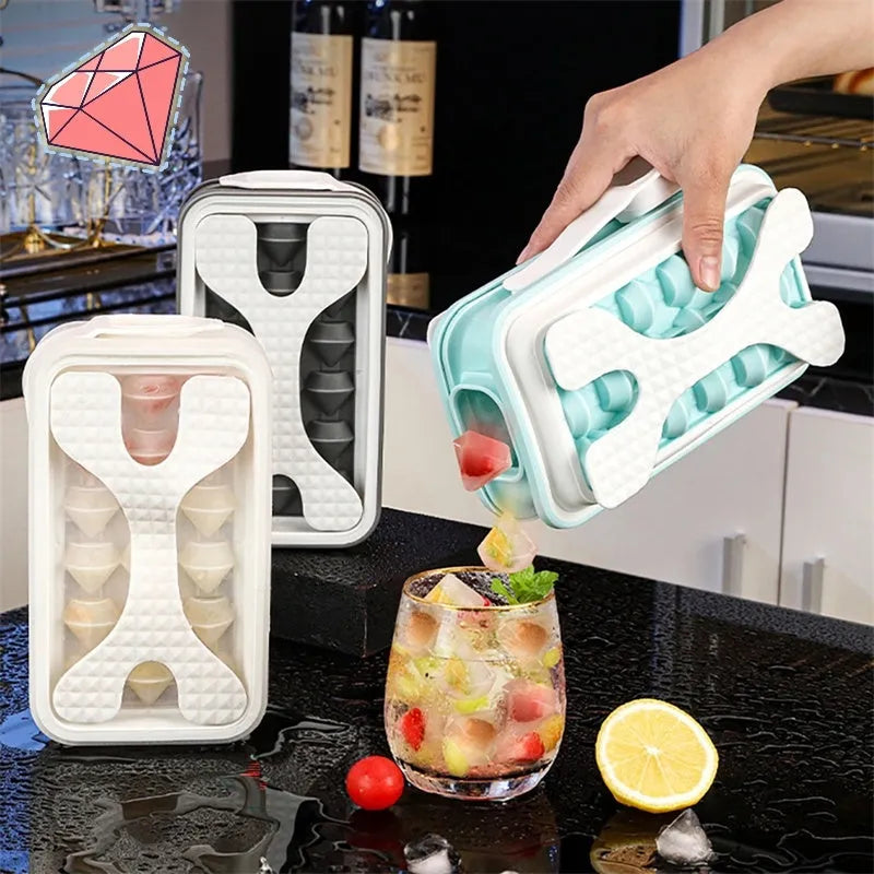 Light grey silicone ice ball mould and water bottle with lid on a kitchen counter.