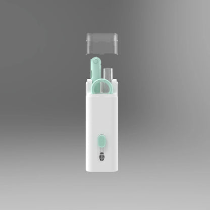 White electronics cleaning kit with a cleaning pen, spray bottle, brush, and keycap puller on a table