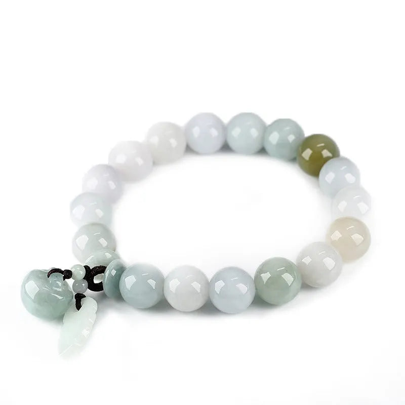 Natural green jade charm bracelet with carved apple and geometric stone pendants.