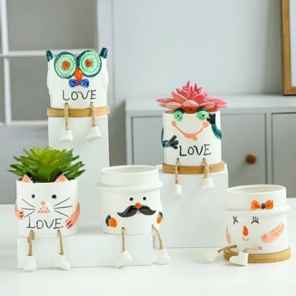 Ceramic hanging foot flowerpot with cartoon design for succulents on desktop