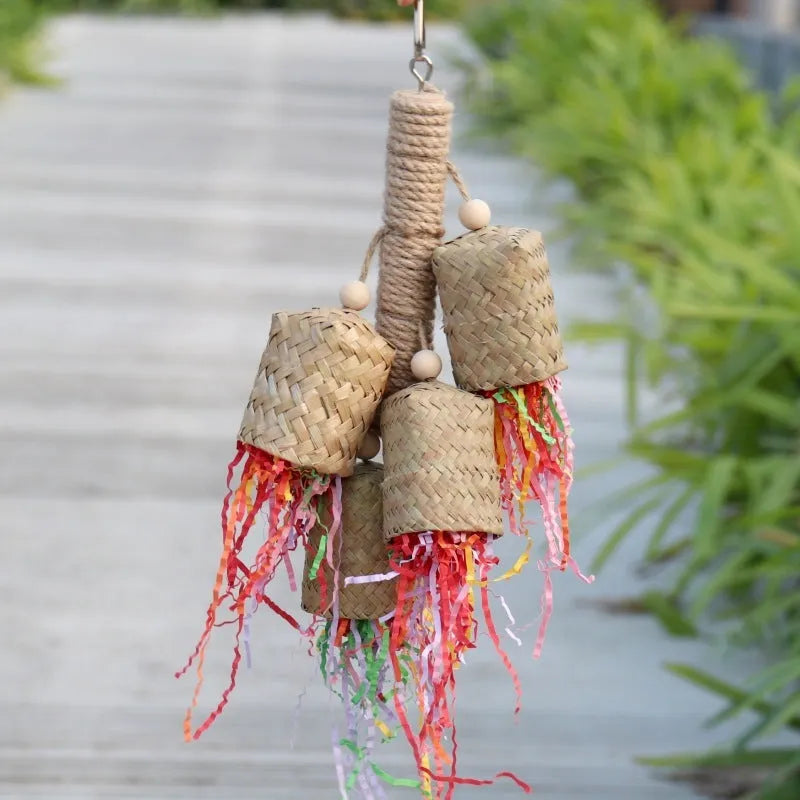 Natural wood and sisal rope shredded paper parrot activity toy measuring 15 by 35 centimetres.