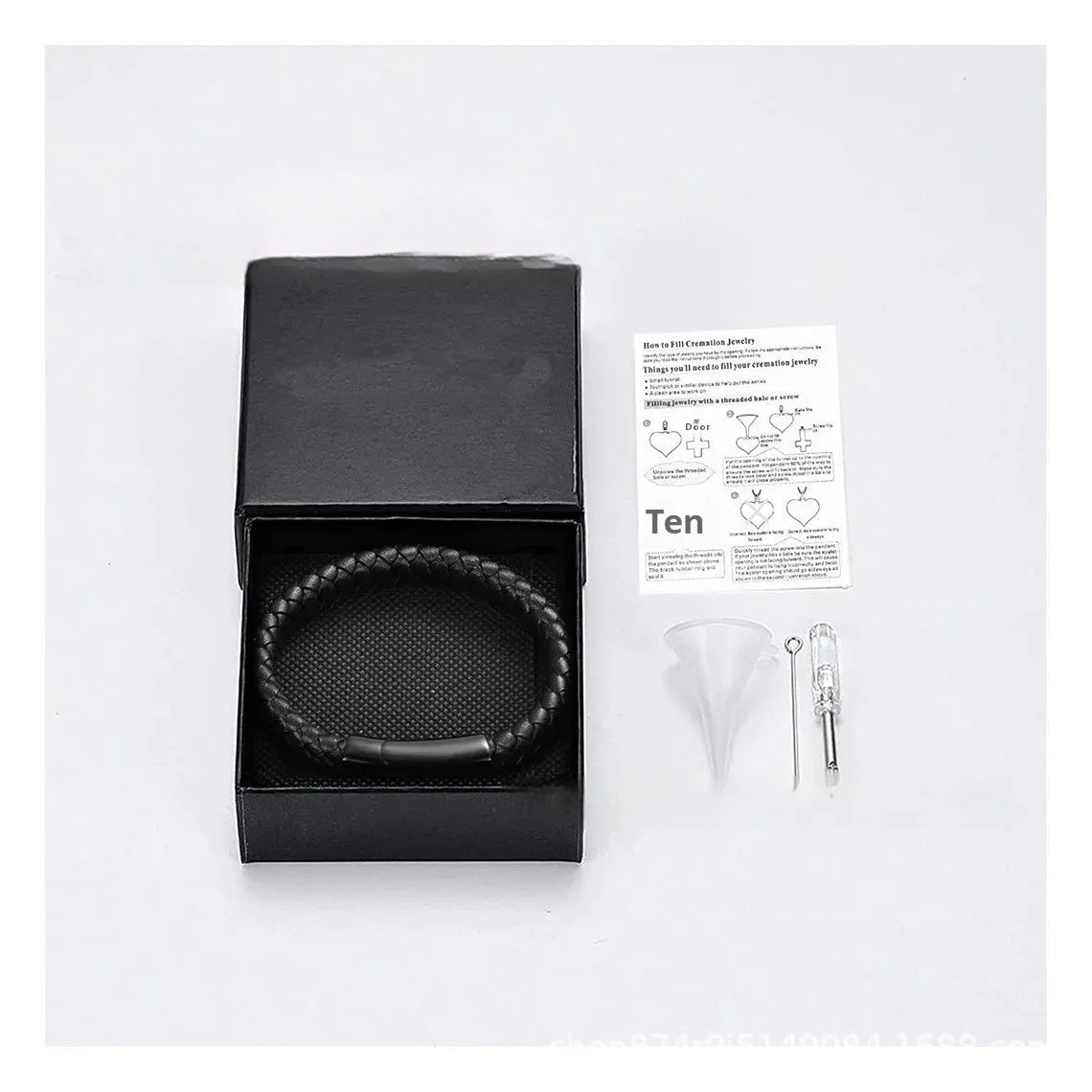 Black leather and stainless steel cinerary bracelet with personalised English letters, presented in a gift box.
