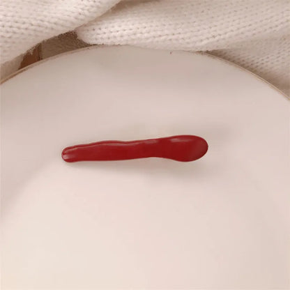 Red love heart-shaped hair barrette clip with retro white dots on a willow leaf-shaped base.