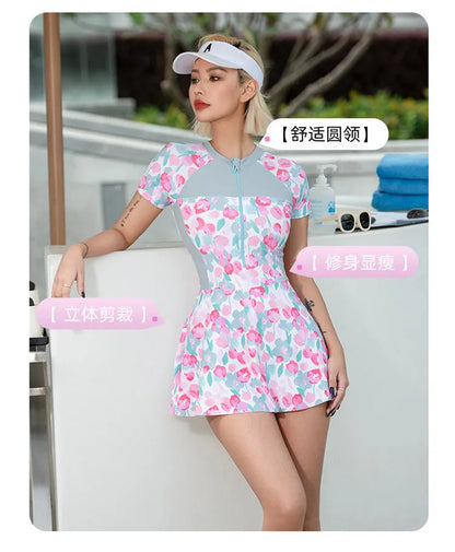 Printed plus size one-piece swimsuit on hanger, showing colourful pattern.