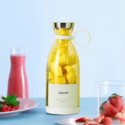 Handheld portable mini juicer in pink with USB charging cable and measuring 18cm tall
