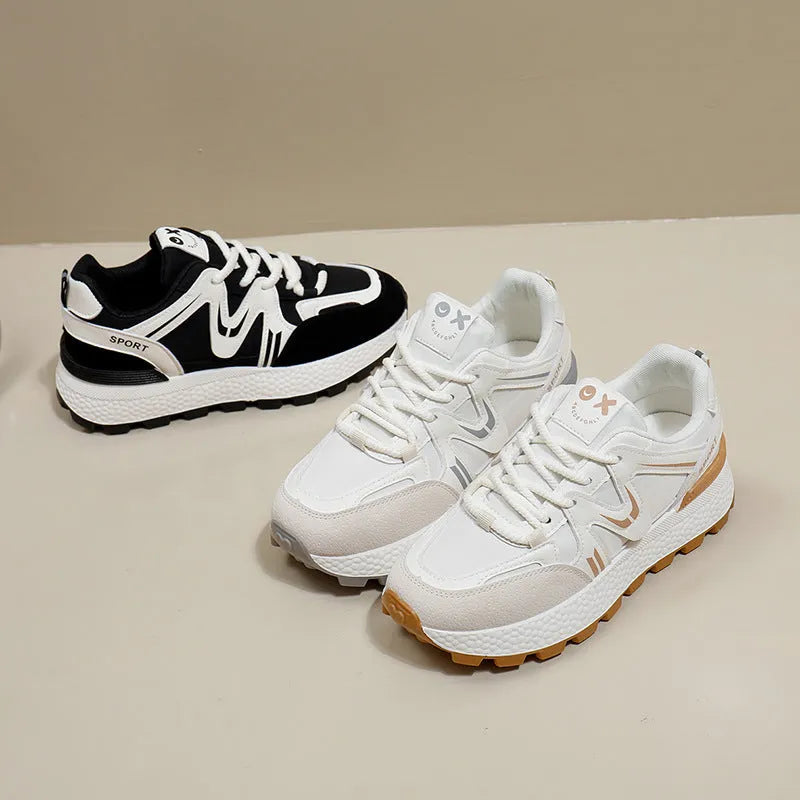 Women's black sports casual shoes with round toe and front lace-up design on a flat heel.