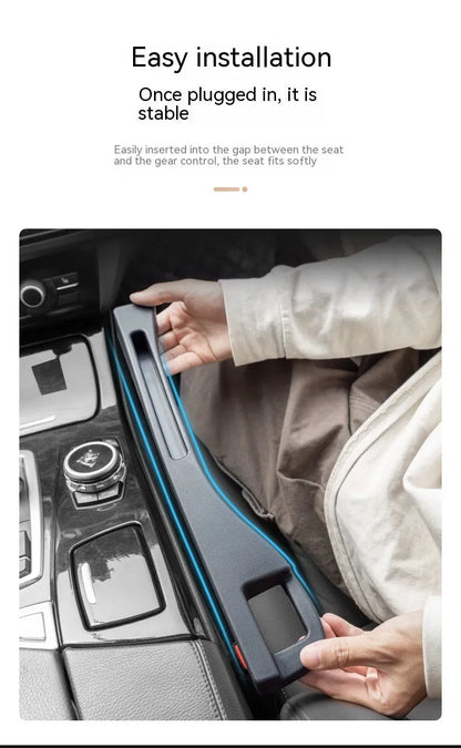 Black car seat gap storage box organiser with compartments and carrying handle between vehicle seats