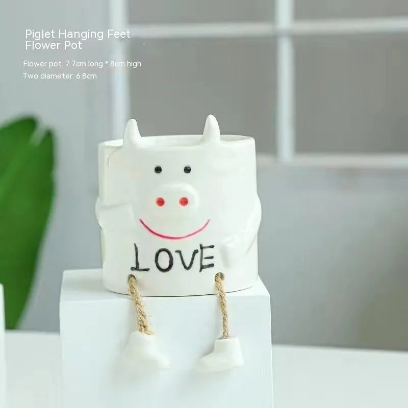 Ceramic hanging foot flowerpot with cartoon design for succulents on desktop