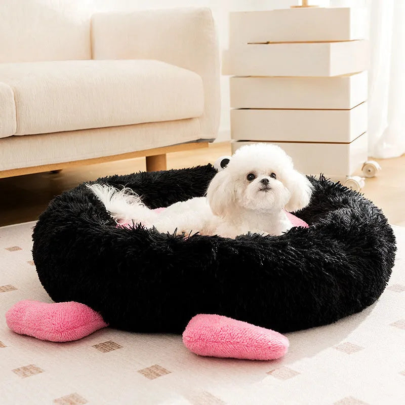 Blue plush kennel bed for dogs or cats with raised sides, shown in a home setting.