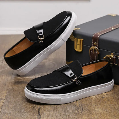 Men's black slip-on shoes with a gold horsebit buckle detail and round toe.