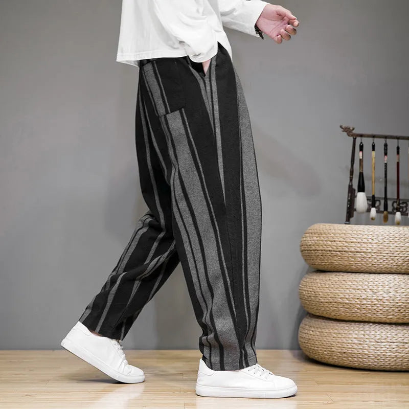Navy blue and black striped men's casual trousers with a non-elastic waistband laid flat.