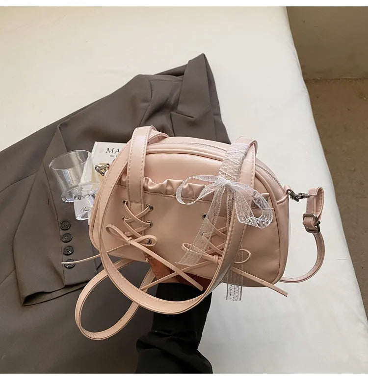 Women's PU leather casual shoulder handbag with a large bandage bow and sewing thread detail.