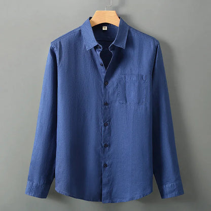 Man wearing a loose-fit light grey long sleeve linen cardigan shirt with a Chinese style design.