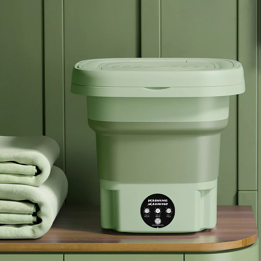 Green folding washing machine measuring 26x26x27cm with USB power cable and mechanical dial controls