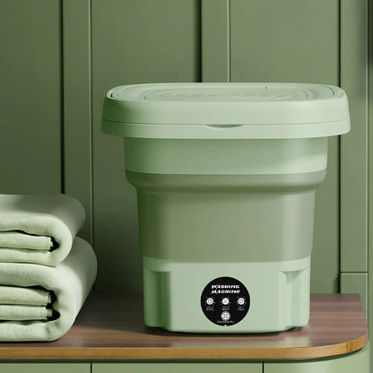 Green folding washing machine measuring 26x26x27cm with USB power cable and mechanical dial controls
