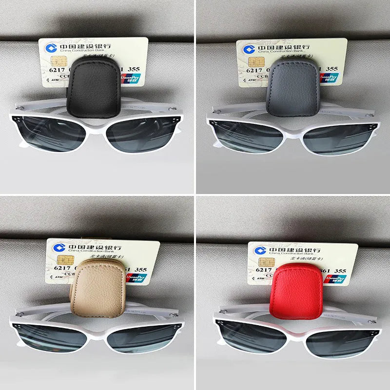 Car sunglasses holder clip with PU leather case attached to a sun visor.