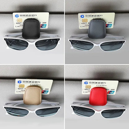 Car sunglasses holder clip with PU leather case attached to a sun visor.
