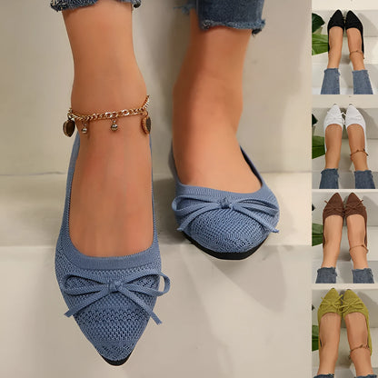 Women's blue knitted loafer flat shoes with a pointed toe and decorative bow detail on the front.
