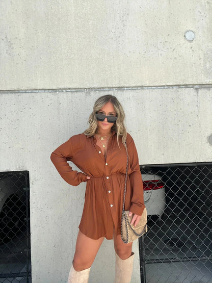 A stylish long sleeve jumpsuit with a button-up shirt design, available in a variety of vibrant colors.