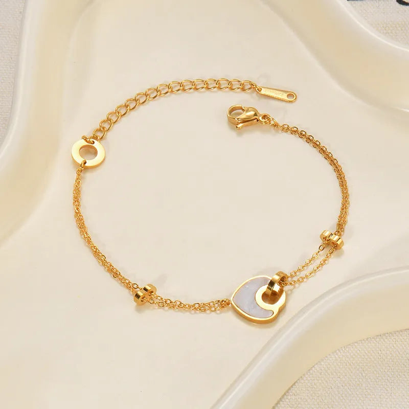 Women's stainless steel bracelet with double-layered heart design and resin accents, showing adjustable clasp and electroplated finish