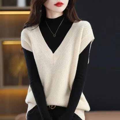 Women's creamy-white V-neck sleeveless vest with a raised 3D knit pattern texture, laid flat.