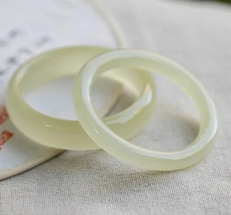 Ice silk jade round bar bracelet shown on a wrist, highlighting its smooth cylindrical shape and natural stone material.