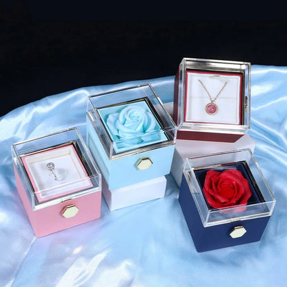Rotating rose jewellery gift box with a preserved red rose under a clear acrylic dome, showing the interior rotating drawer.