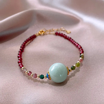 Women's garnet bracelet with aquamarine tourmaline drop charm and electroplated finish