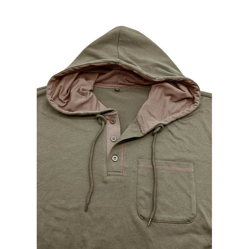Man wearing a grey hooded henley long-sleeved t-shirt, showcasing the pullover style and cotton blend fabric.