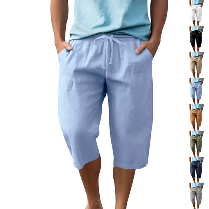 Men's loose-fit linen shorts in a solid colour with a drawstring waist and cropped leg length.