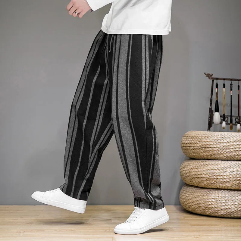 Navy blue and black striped men's casual trousers with a non-elastic waistband laid flat.