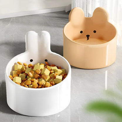 Blush Critter ceramic pet bowls in white rabbit and brown bear designs, showing neck protection rim.