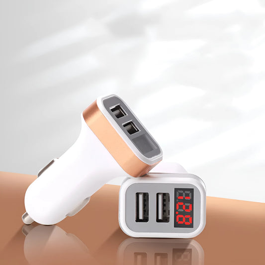 Gold and silver coloured 2.1A digital display car charger showing compact size next to a mobile phone