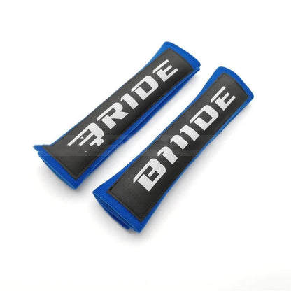 Car seat belt shoulder pad protectors in black, blue, and red colours with embroidered woven detailing