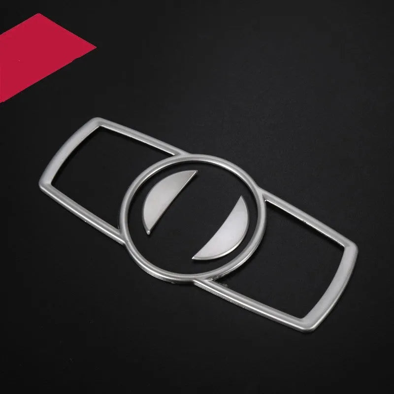Silver ABS plastic decorative sticker for BMW headlight switch frame on dashboard.