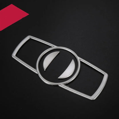 Silver ABS plastic decorative sticker for BMW headlight switch frame on dashboard.