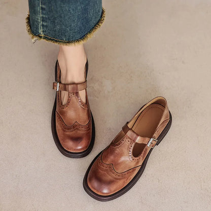 Women's black and brown round-toe flat casual shoes made from sheepskin leather.