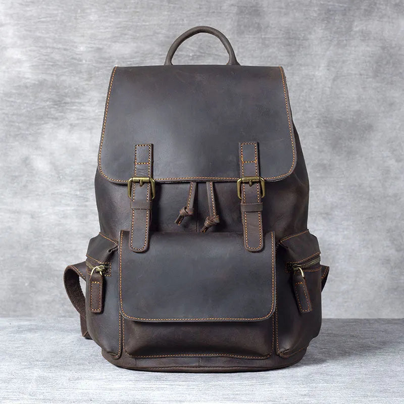 Retro brown genuine cowhide leather backpack with shoulder straps and a top handle.