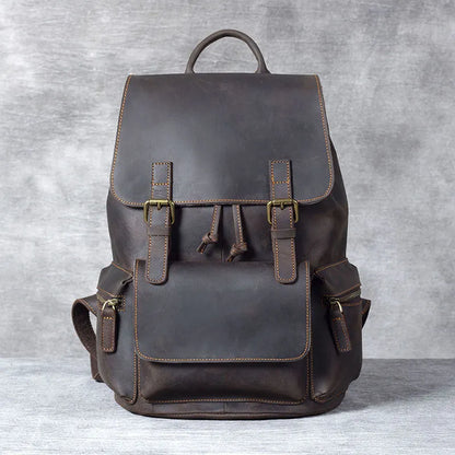 Retro brown genuine cowhide leather backpack with shoulder straps and a top handle.