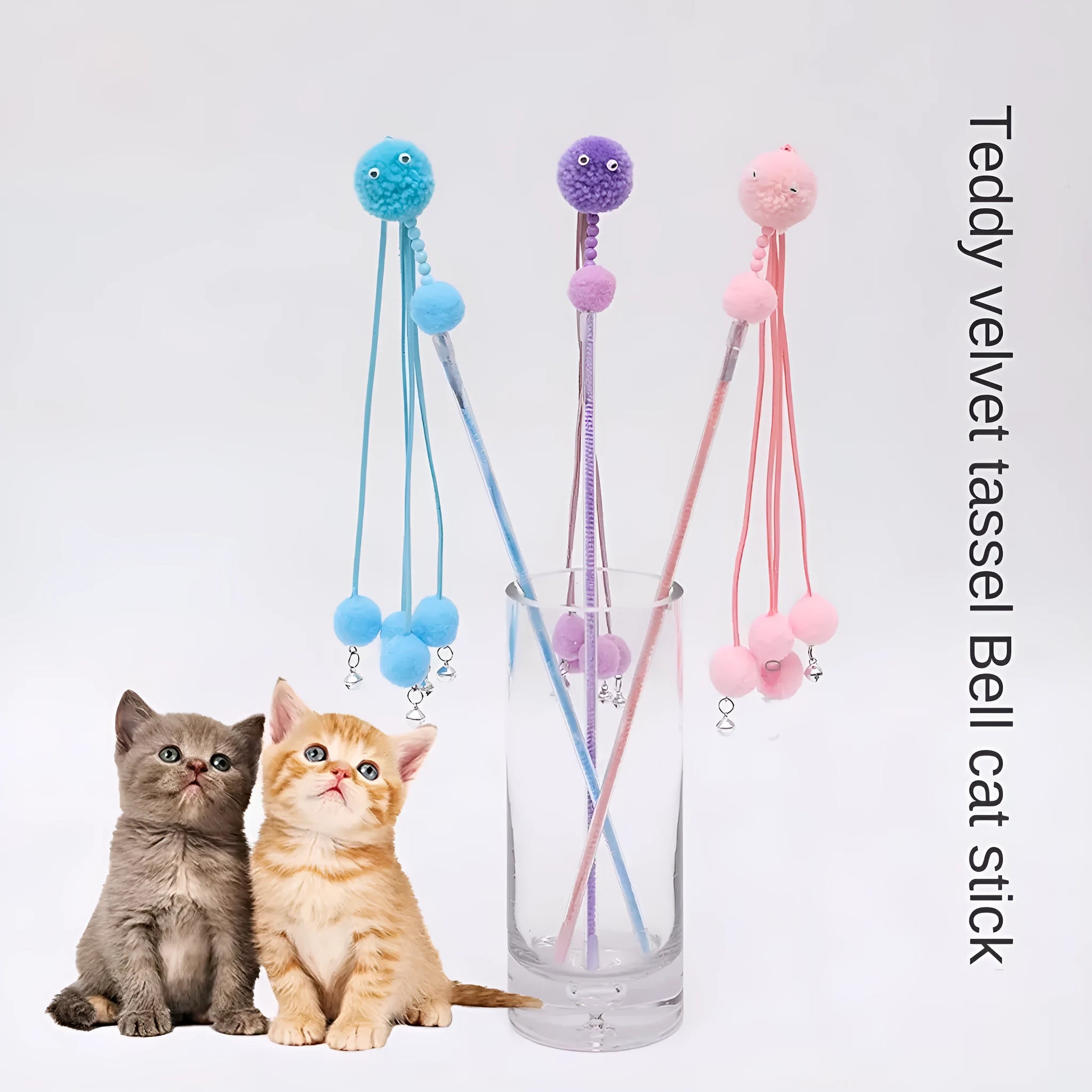 Set of four colourful cat stick toys with dangling tassels, showing blue, pink, and purple handles.