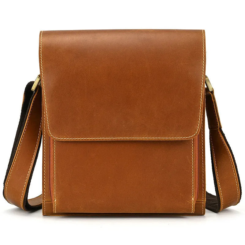 Men's brown first layer cowhide leather shoulder bag with crossbody strap and visible sewing line details.